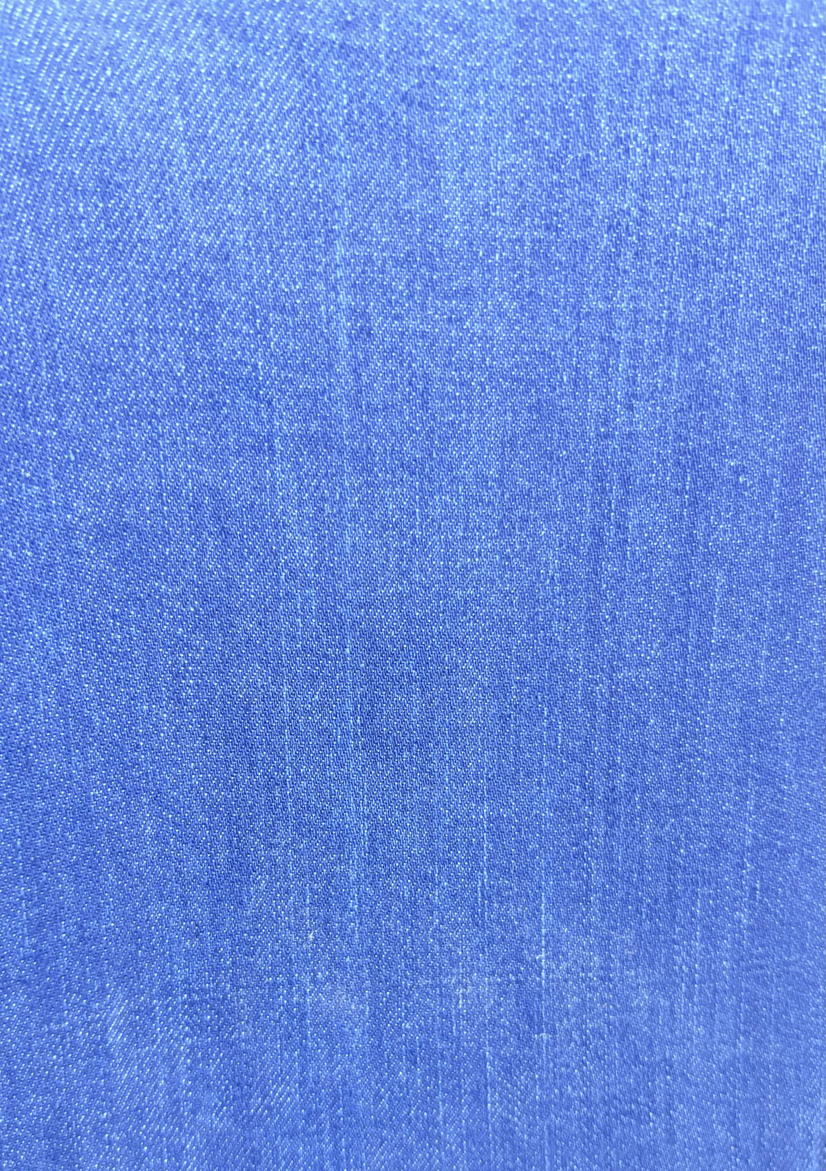 The indigo cloth, its blue warp crossed by a white weft