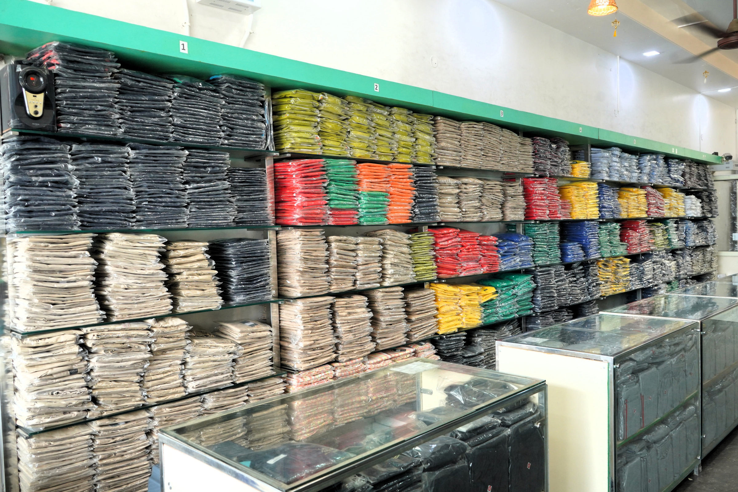 Colour-blocked stock above the glass counter at Kharar