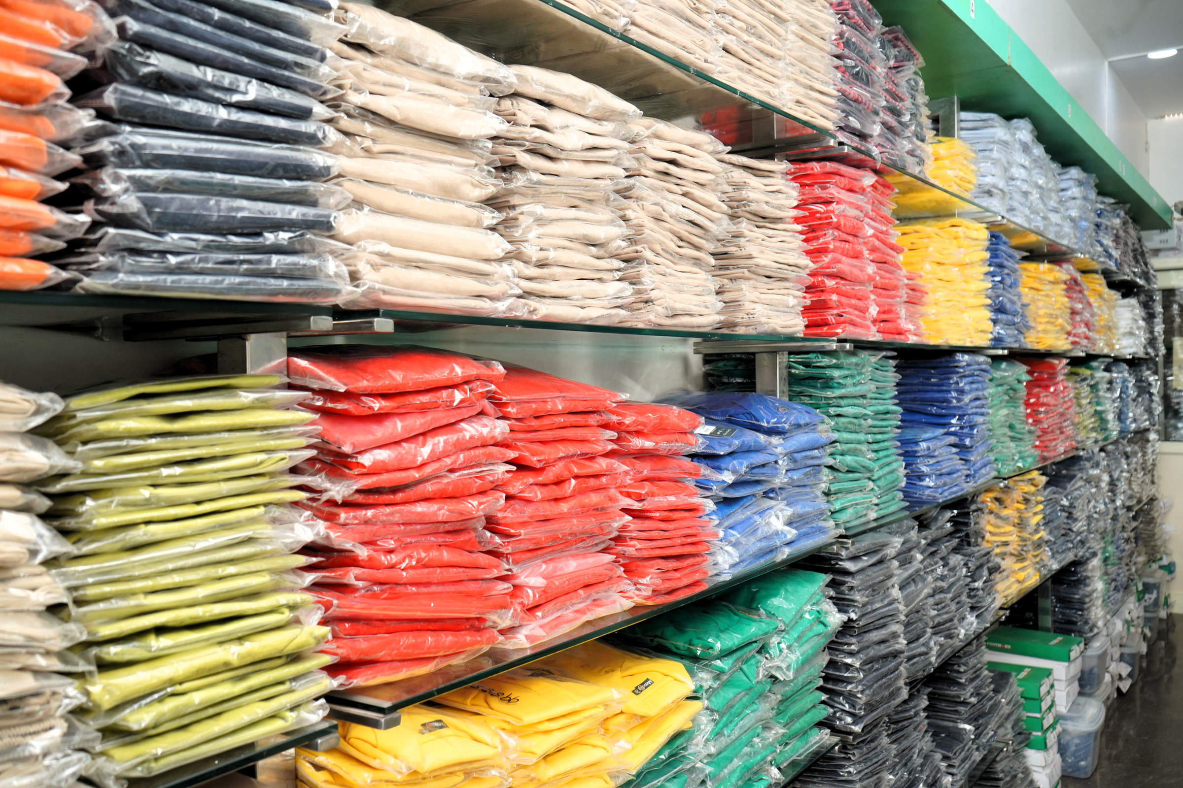 Folded uniform stacked by colour on the Kharar shelves