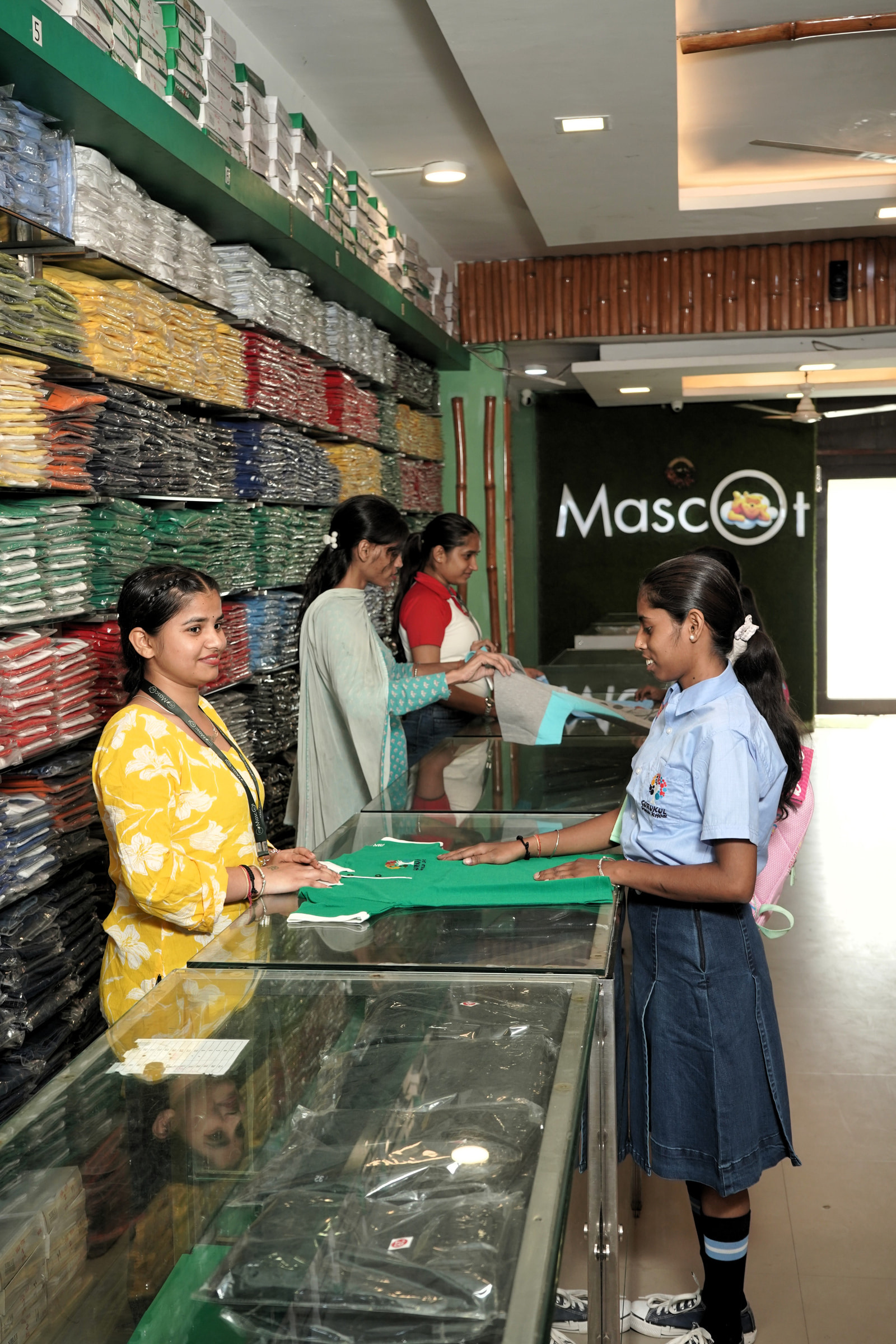 Staff and a pupil at the Mohali counter, a shirt unfolded between them
